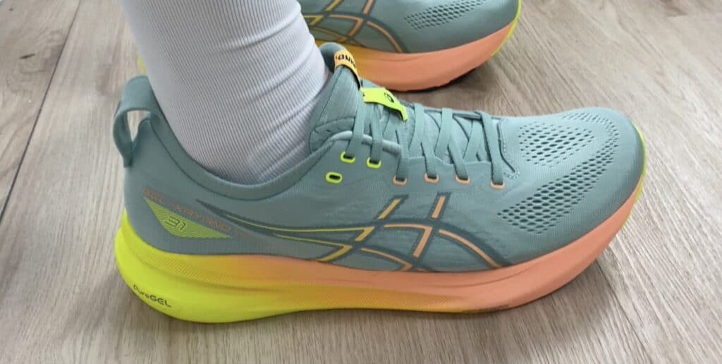 Side view of the ASICS Gel-Kayano 31 showcasing the shoe’s stability features, sole flare, and cushioning design.