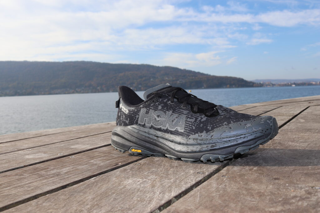 Picture of the side of the Hoka Speedgoat 6 at annecy lake