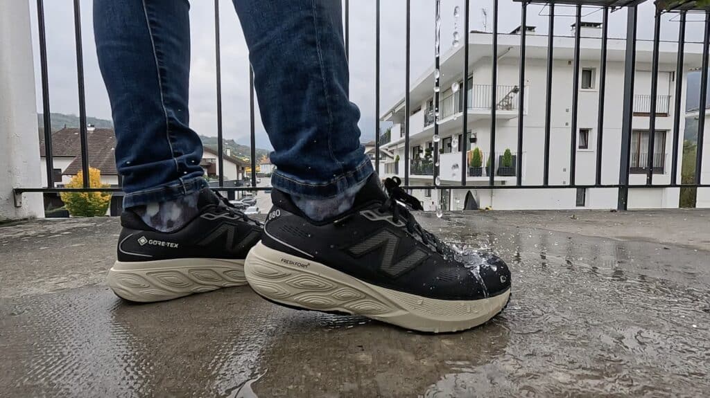 New Balance 880 v15 Gore-Tex shoes splashing through puddles, showing waterproof protection, cushioning, and wide fit design.