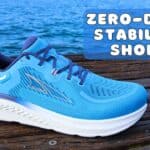 Picture of the Discover the Altra Paradigm 7 from the side in blue and white at annecy lake with a caption saying zero-drop stability shoes