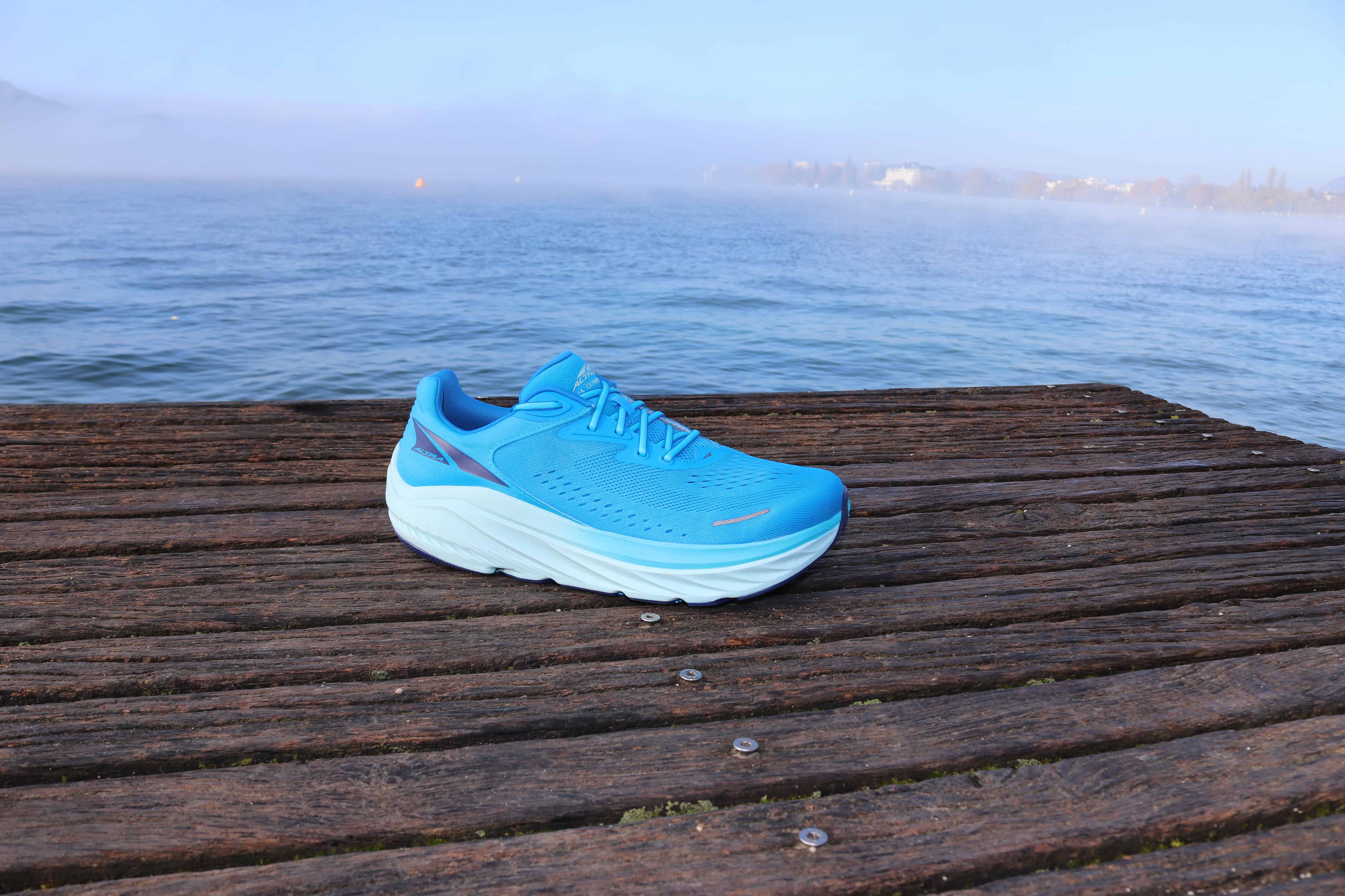 Picture of the Altra Via Olympus 2 in blue from the side at annecy lake