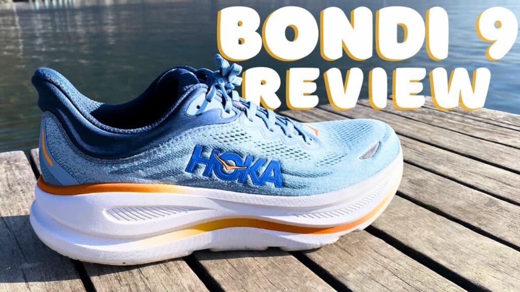 Picture of the hoka bondi 9 in blue, white and orange from the side at annecy lake with the caption of Bondi 9 Review