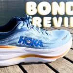 Picture of the hoka bondi 9 in blue, white and orange from the side at annecy lake with the caption of Bondi 9 Review