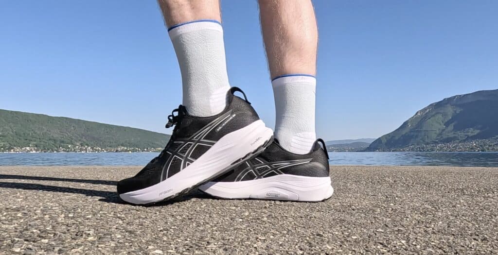 Photo of james mccormack wearing the asics gel kayano 32 in black and white with a side view of the shoes