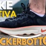 Picture of the nike motiva from the side in navy orange and white