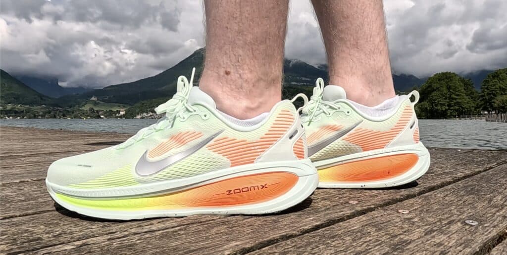 Nike Vomero 18 lime green and orange in split stance