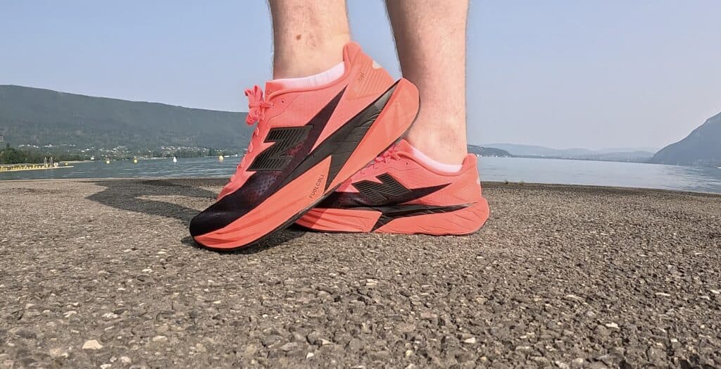 Picture of the New balance rebel v5 in red and black from the side