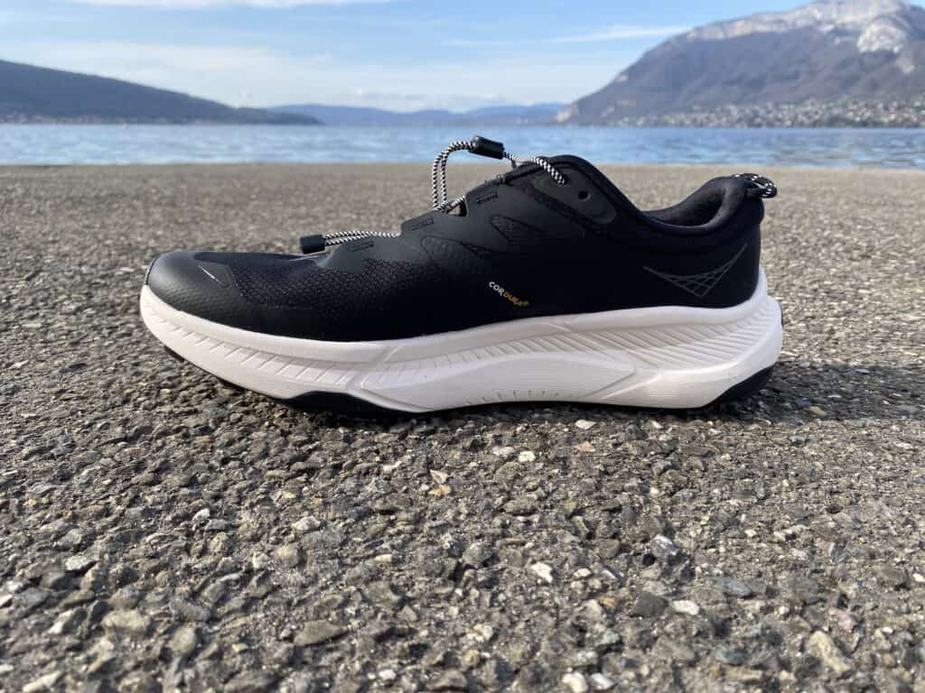 Side view of the Hoka Transport walking shoe in neutral colour, showing the Vibram outsole and CMEVA midsole.