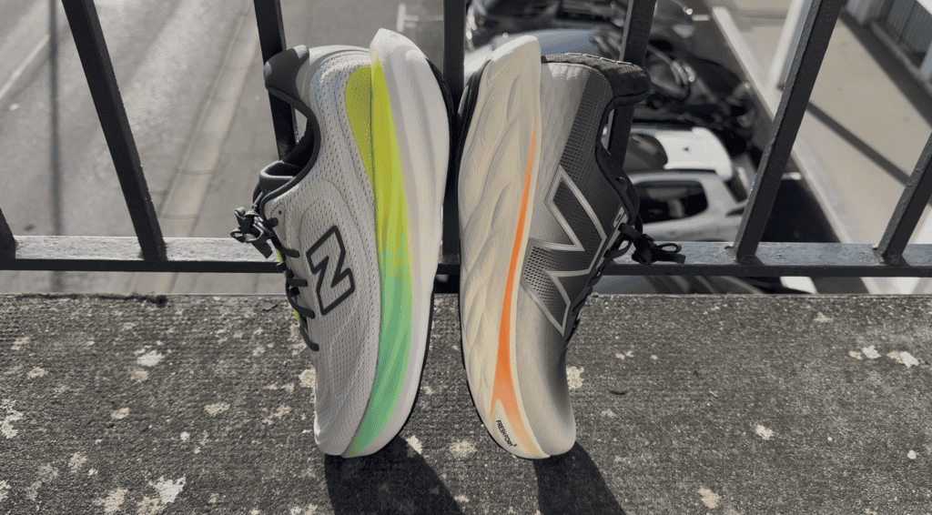 Photo from a side view of the midsoles of the New Balance 1080 v15 vs v14. The v15 is on the left and v14 on the right